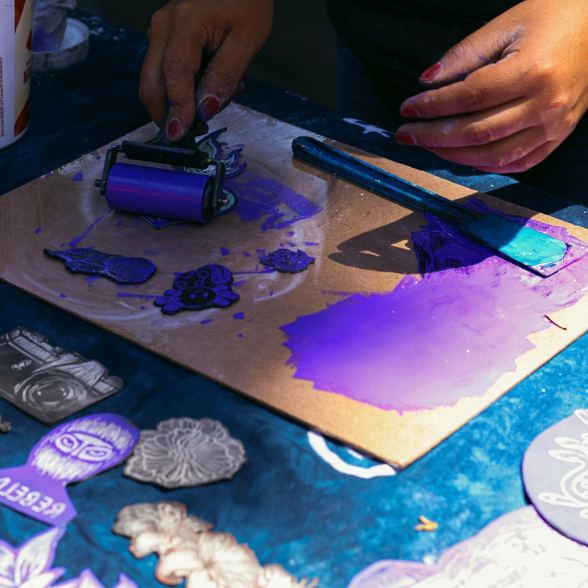Rolling purple ink onto a plate for a monotype